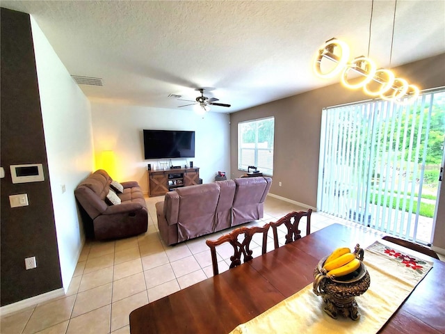 dining room with light tile patterned floors, a textured ceiling, and ceiling fan