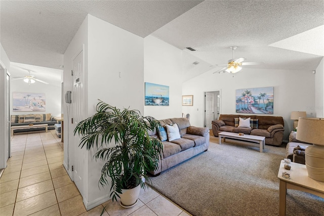 tiled living room with a textured ceiling, ceiling fan, and lofted ceiling