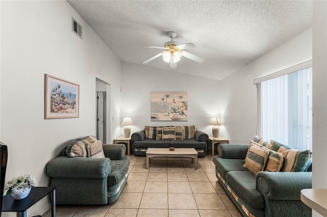 tiled living room featuring a textured ceiling, vaulted ceiling, and ceiling fan