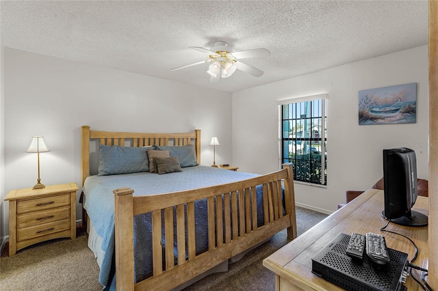 carpeted bedroom with a textured ceiling and ceiling fan