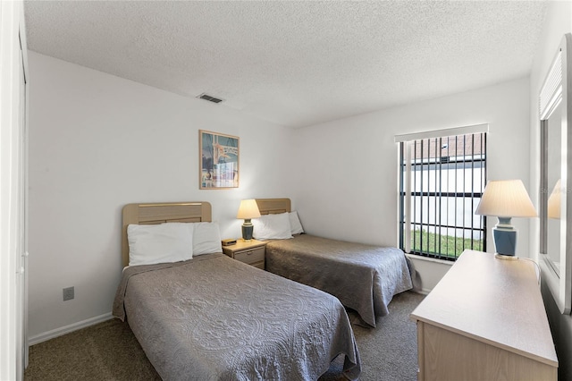 carpeted bedroom featuring a textured ceiling