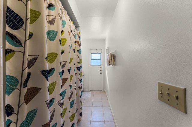 hallway featuring light tile patterned floors