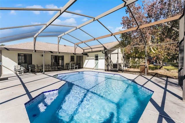 view of pool with a patio and glass enclosure