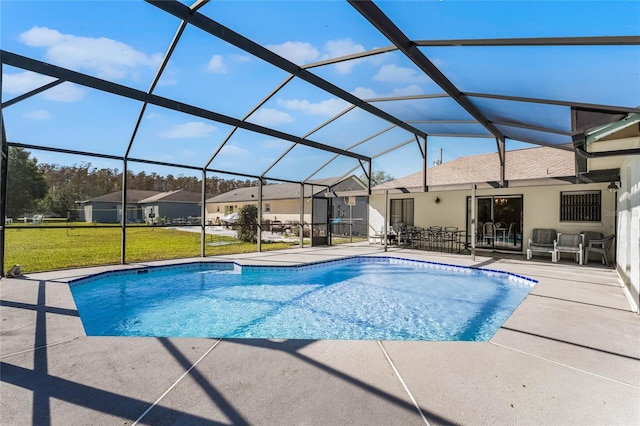 view of pool featuring a lawn, glass enclosure, and a patio area