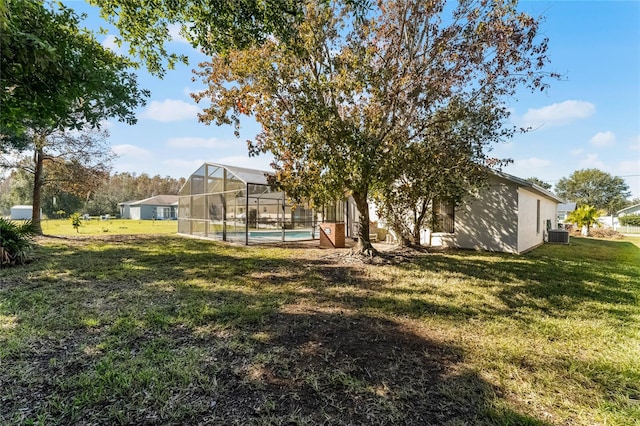 view of yard with a fenced in pool, glass enclosure, and cooling unit