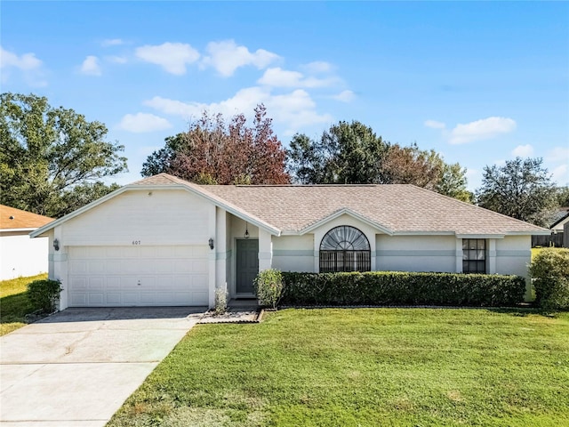 single story home with a garage and a front lawn