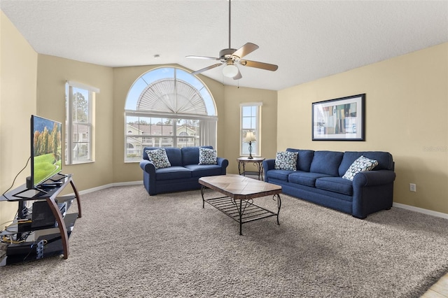 carpeted living room with lofted ceiling, ceiling fan, and a textured ceiling