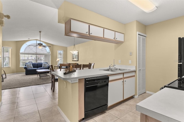 kitchen featuring dishwasher, white cabinets, hanging light fixtures, and lofted ceiling