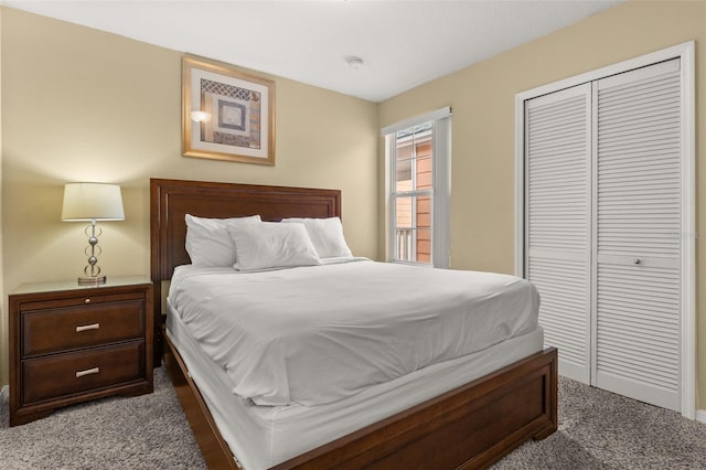 bedroom featuring a closet and dark colored carpet