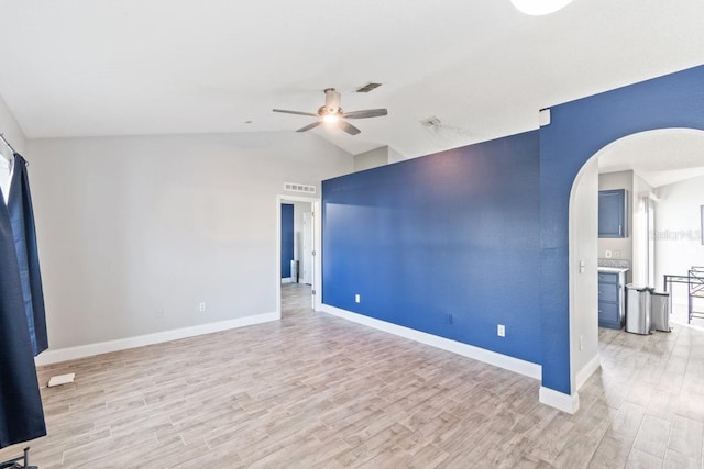 empty room with ceiling fan, light hardwood / wood-style floors, and lofted ceiling