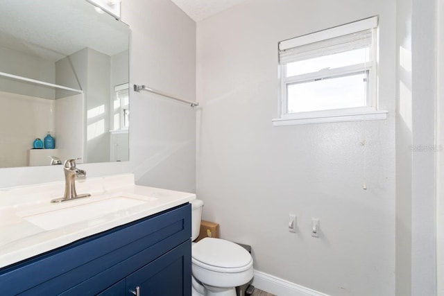 bathroom featuring a shower, vanity, a textured ceiling, and toilet