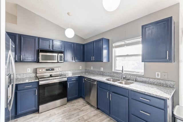 kitchen featuring sink, stainless steel appliances, blue cabinets, vaulted ceiling, and light wood-type flooring