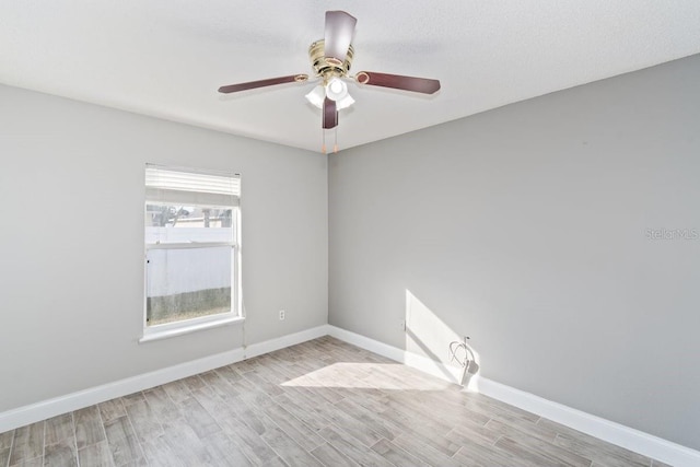 spare room featuring ceiling fan, light hardwood / wood-style floors, and a textured ceiling