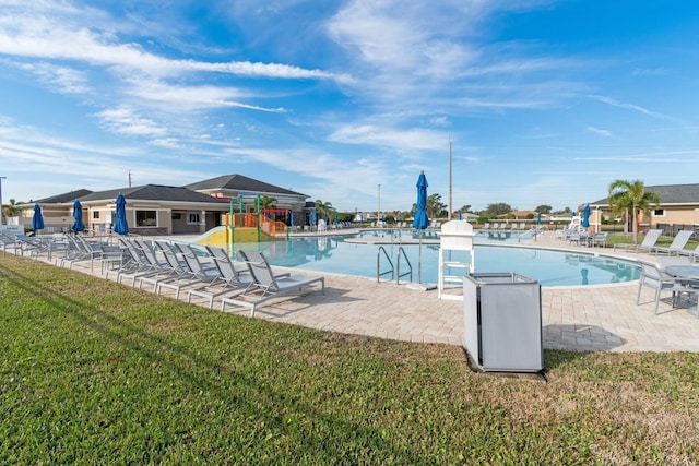 view of swimming pool featuring a lawn and a patio area