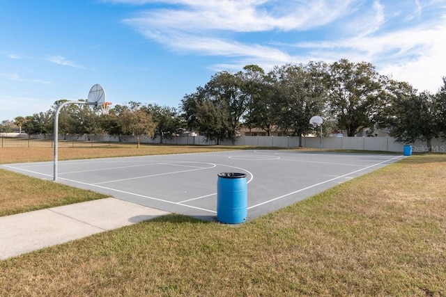 view of basketball court with a lawn