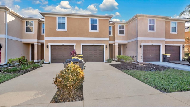 1336 Chelsea Dr, Davenport, FL 33897 - view of property with an attached garage, stucco siding, and driveway