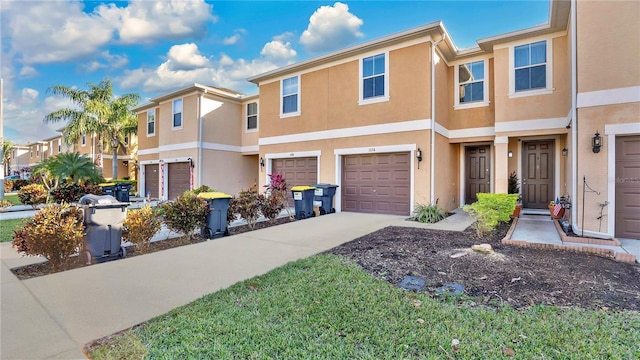 1336 Chelsea Dr, Davenport, FL 33897 - view of property featuring concrete driveway, stucco siding, an attached garage, and a residential view