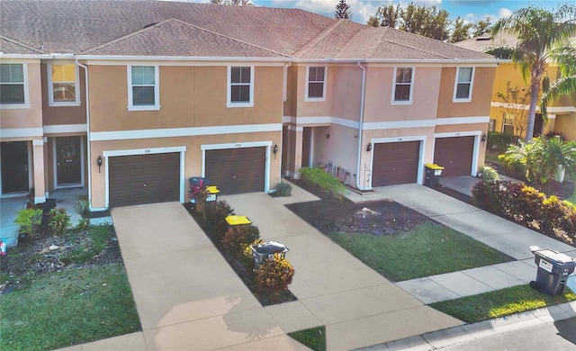 1336 Chelsea Dr, Davenport, FL 33897 - multi unit property with a garage, stucco siding, driveway, and roof with shingles