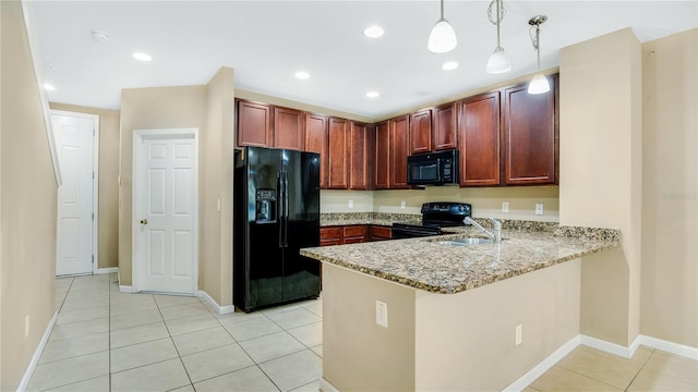 kitchen featuring kitchen peninsula, light stone counters, sink, black appliances, and pendant lighting