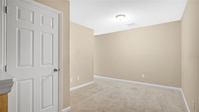 hallway featuring light colored carpet