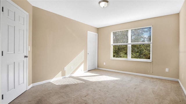 empty room featuring light carpet