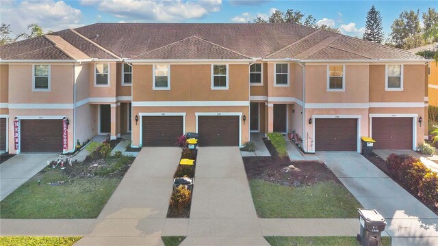 1336 Chelsea Dr, Davenport, FL 33897 - view of property featuring an attached garage, stucco siding, and driveway