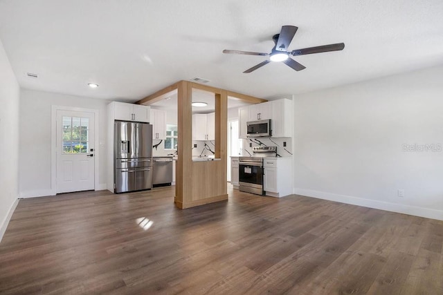 unfurnished living room featuring ceiling fan and dark wood-type flooring