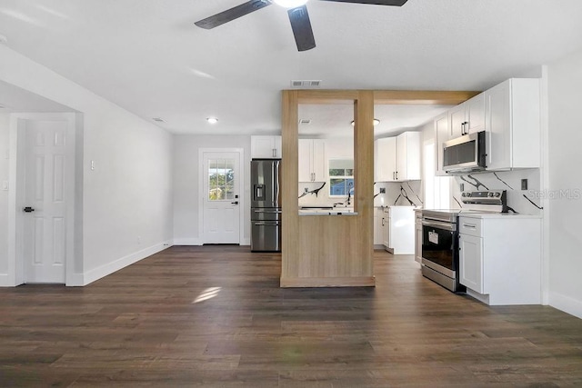 kitchen featuring ceiling fan, white cabinetry, stainless steel appliances, and dark wood-type flooring