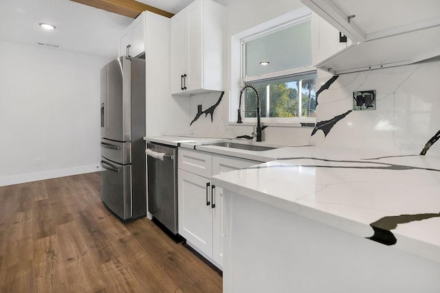 kitchen with sink, white cabinetry, stainless steel appliances, and dark wood-type flooring