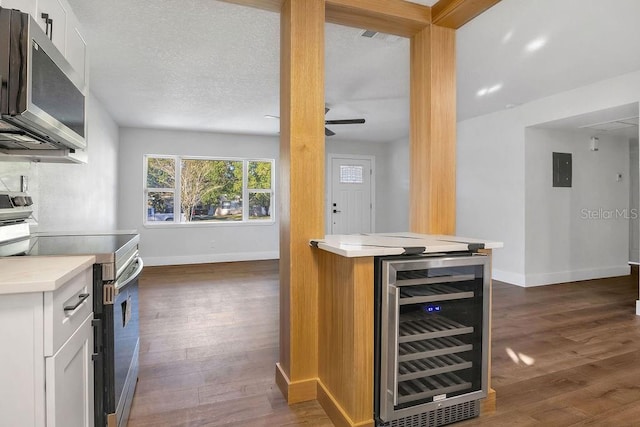 kitchen featuring white cabinets, wine cooler, dark hardwood / wood-style floors, and appliances with stainless steel finishes