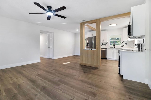 kitchen featuring white cabinets, stainless steel appliances, ceiling fan, and dark wood-type flooring