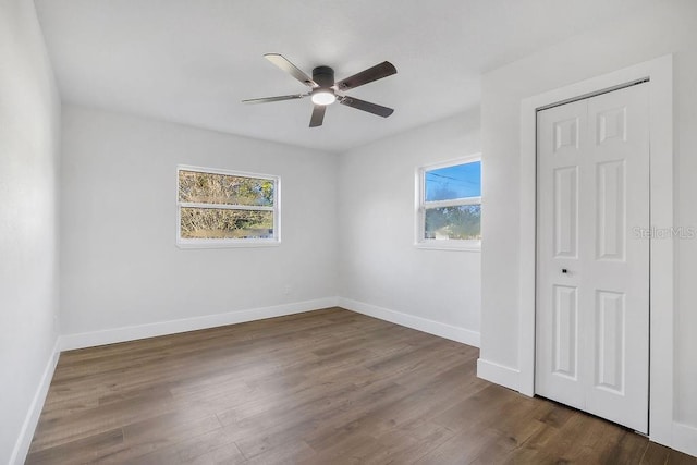 unfurnished room with ceiling fan and dark hardwood / wood-style floors