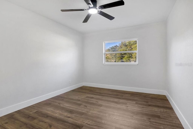 spare room featuring ceiling fan and dark hardwood / wood-style flooring