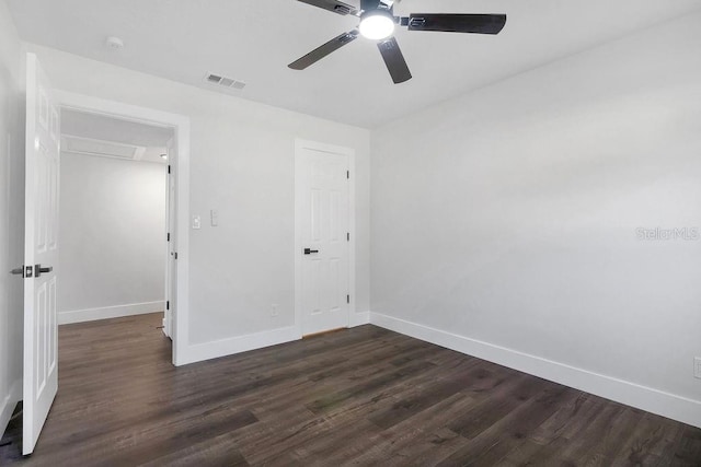 unfurnished bedroom featuring ceiling fan, dark hardwood / wood-style floors, and a closet