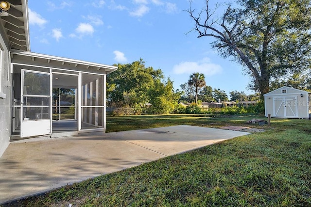 view of yard featuring a sunroom, a patio, and a shed