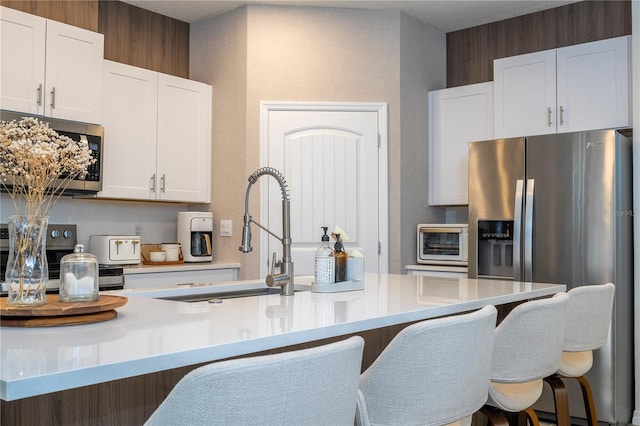 kitchen featuring sink, white cabinets, and appliances with stainless steel finishes