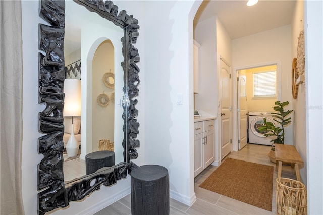 corridor featuring light hardwood / wood-style flooring and washer and dryer