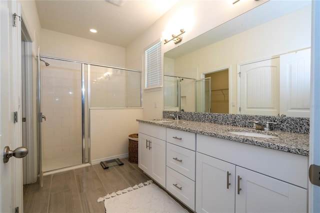 bathroom featuring vanity and a shower with shower door