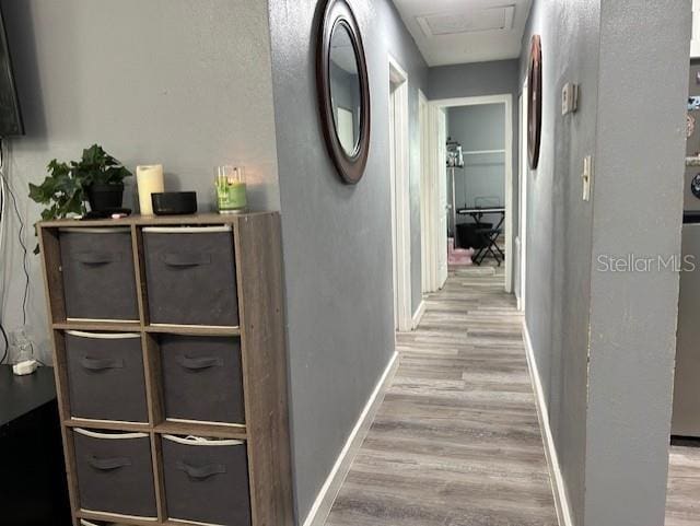 hallway with light hardwood / wood-style flooring