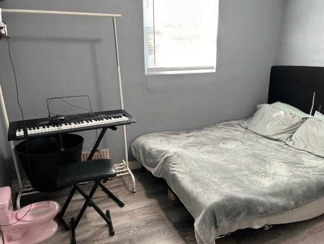 bedroom with hardwood / wood-style flooring