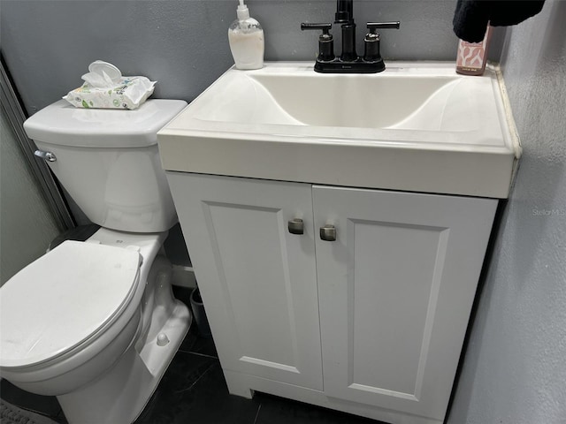 bathroom with tile patterned floors, vanity, and toilet