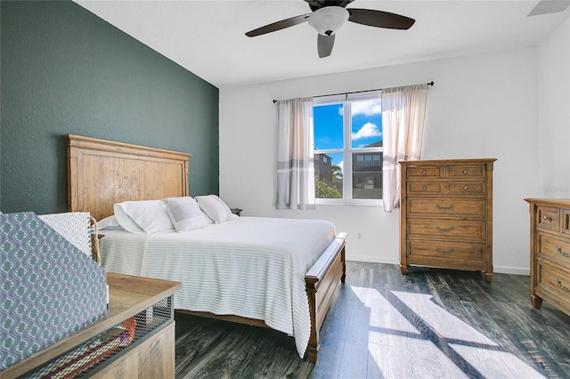 bedroom with ceiling fan, lofted ceiling, and dark wood-type flooring