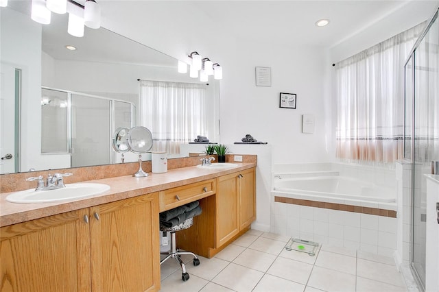 bathroom with tile patterned floors, vanity, a healthy amount of sunlight, and shower with separate bathtub