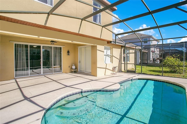 view of pool with a patio, ceiling fan, and a lanai