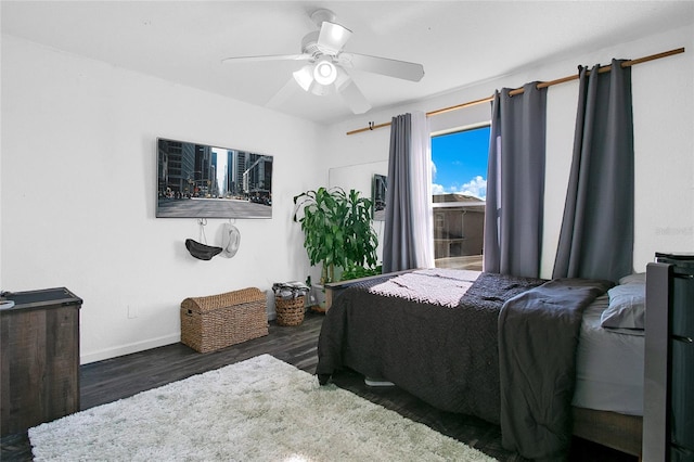 bedroom featuring ceiling fan and dark hardwood / wood-style floors