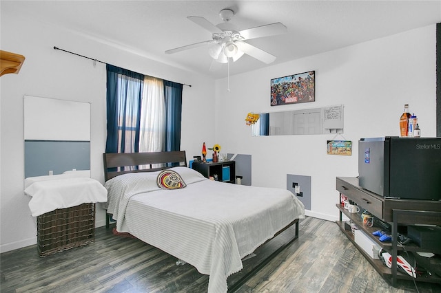 bedroom with ceiling fan and dark hardwood / wood-style floors