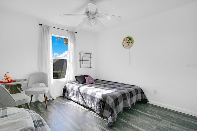 bedroom with ceiling fan and dark hardwood / wood-style flooring