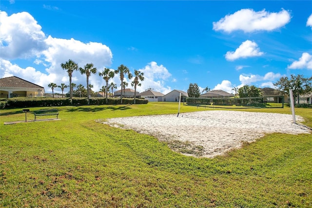 view of home's community featuring a lawn and volleyball court