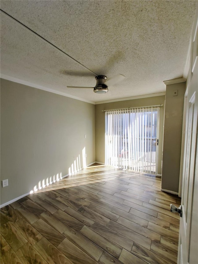 empty room with hardwood / wood-style floors, a textured ceiling, ceiling fan, and crown molding