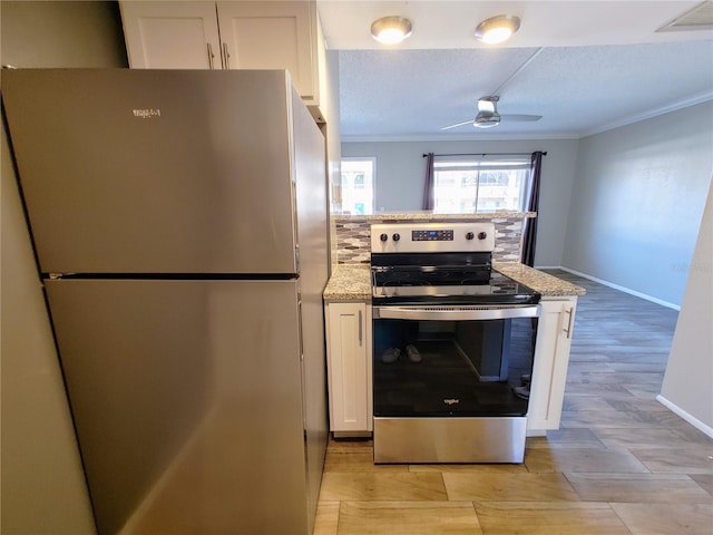 kitchen featuring crown molding, white cabinets, stainless steel appliances, and light stone counters